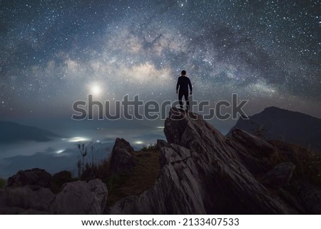 Portrait of man, a tourist, travel at Doi Tung, Chiang Rai, Thailand with mountain hills, the milky way in galaxy with stars at night. Universe space landscape background. People lifestyle. Royalty-Free Stock Photo #2133407533