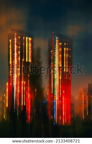 Blurred view of modern two skyscraper, glowing building at night, abstract background