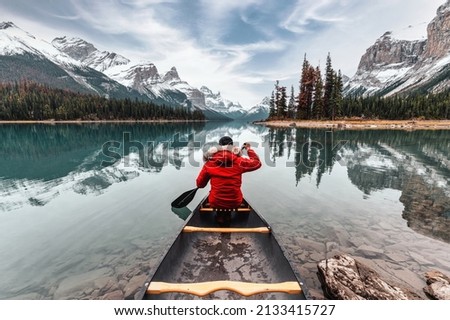 Male traveler in winter coat canoeing in Spirit Island on Maligne Lake at Jasper national park, AB, Canada Royalty-Free Stock Photo #2133415727