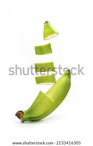 Whole bananas and slices are flying close-up on a white background.