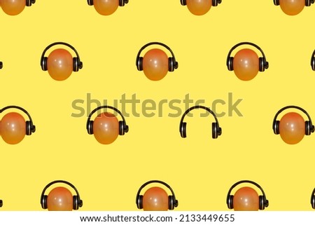 balloon with headphones creative concept balloon that carries headphones all over the pastel yellow background and one headphones without balloons break the pattern