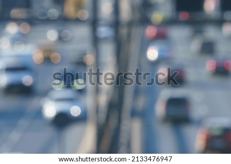 Defocused photography of traffic on Moscow city highway. Road is filled out by cars. Rush hours. Bright lifestyles of big city concepts. Soft colors. High angle view, top view. Backs, rear and frontal