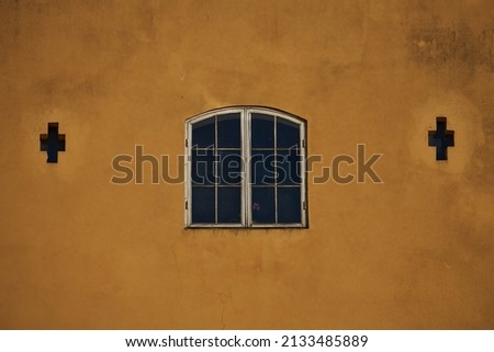 Greek style window on yellow concrete wall color Royalty-Free Stock Photo #2133485889