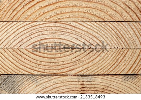 Stacks of pine wood planks. Natural rough wooden boards boards, lumber, industrial wood, timber. Royalty-Free Stock Photo #2133518493