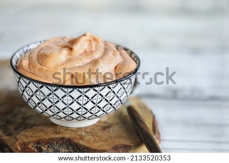 Japanese American yum yum sauce made with mayo, sugar, paprika, ketchup, rice vinegar, butter, onion powder, garlic powder and mirin.  Selective focus with blurred foreground and background. Royalty-Free Stock Photo #2133520353