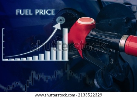 Pumping gasoline fuel nozzle to refuel with graphic increase of fuel price. Vehicle fueling facility at petrol station