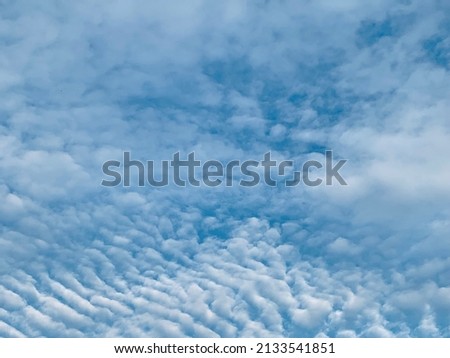 Altocumulus clouds have beautiful streaks in the atmosphere. They often appear between the lower stratus clouds and the higher cirrus clouds at Thailand.no focus