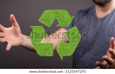 A Caucasian man hands holding green recycle sign, three arrows 3D