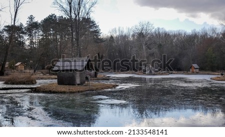 small house on the island by the frozen lake