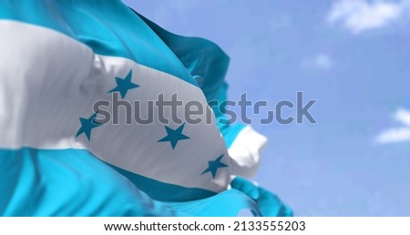 Detail of the national flag of Honduras waving in the wind on a clear day. Honduras is a country in Central America. Selective focus. Royalty-Free Stock Photo #2133555203