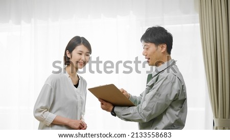 Man in work clothes explaining to homeowner Image of safety inspection	
