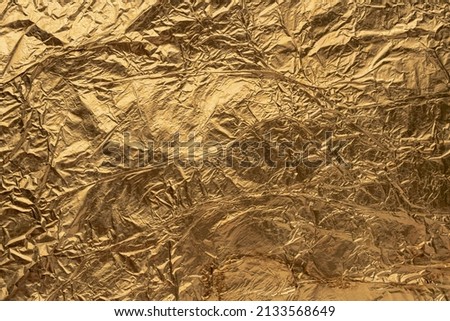 top view of rumpled sheet golden foil. High quality photo