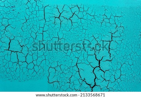 Cracked and damaged painted surface of a building or wall. Texture, aged paint background. High quality photo
