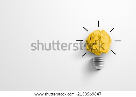 Creative thinking ideas and innovation concept. Paper scrap ball yellow colour with light bulb symbol on white background Royalty-Free Stock Photo #2133569847