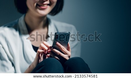 A young woman with a mental disorder uses a smartphone.	 Royalty-Free Stock Photo #2133574581