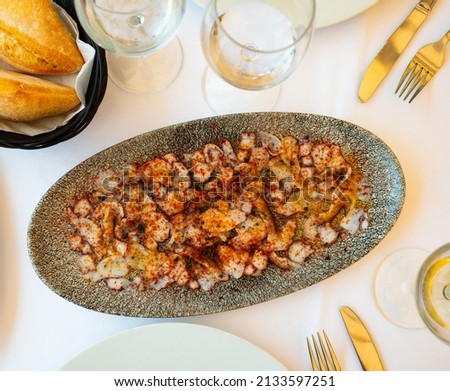 National appetizing dish of Italian cuisine is octopus carpaccio, served on a platter