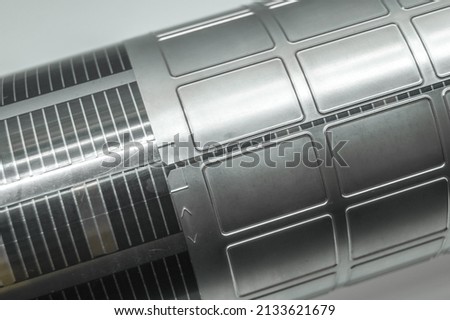 Used magnetic cylinder with attached flexible die for die cutting on rotary printing press. Die-cutting of labels. Cut knife for paper labels. Rotary stamp. Offset cutting knife for printing machine Royalty-Free Stock Photo #2133621679