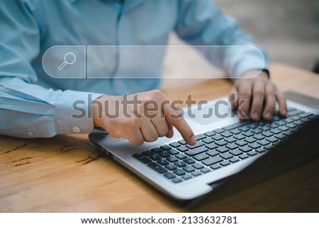 Search technology, search engine optimization,man's hand using laptop computer keyboard to search information,using search engine bar function on your website.People who work in cafes