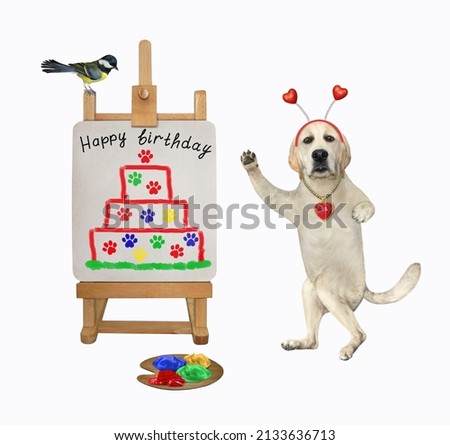 A dog labrador artist in a holiday headband painted a birthday cake on a canvas on an easel. White background. Isolated.