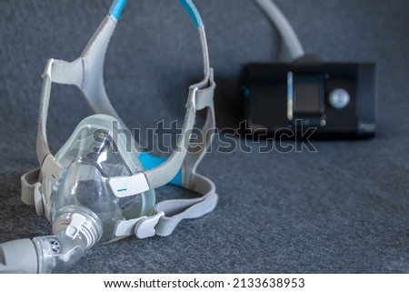 CPAP mask with a full face mask cpap machine against obstructive sleep apnea helps patients as respirator mask and headgear clip for breathing medication in snoring sleep disorder to breath easier Royalty-Free Stock Photo #2133638953