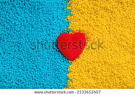The Ukrainian flag is made of blue and yellow backgrounds and red hearts. The concept of Ukrainian motivation