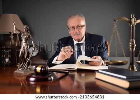 The lawyer signs documents in the office. Law concept.