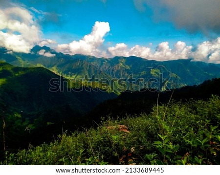 A rain forest landscape picture of mountain , green valley, cloud formation 