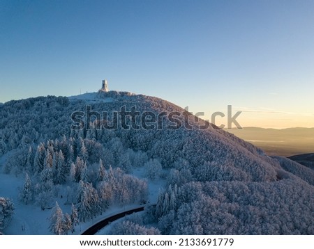 A serene landscape of the snow covered Shipka summit in Bulgaria at sunset