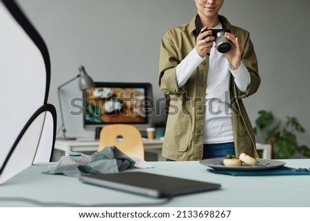 Cropped portrait of young food photographer taking pictures in studio, digital creator concept