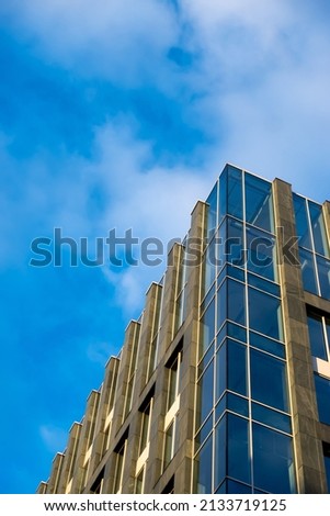 Facade of a modern apartament building against a blue sky background. Photo taken at late afternoon on a sunny day.