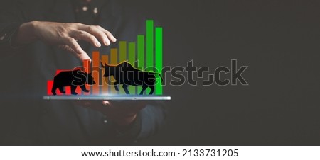 investment background, drawing of a bull and a bear on the hand of a market maker on a candlestick chart, Wall Street speculation concept, market trends, index, stock broker, financial advisor,
