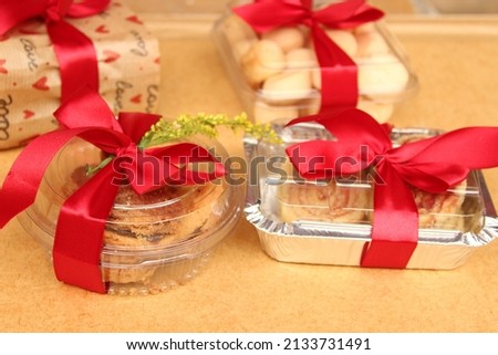 Red bow in gift box at festivities. Decorative ribbon.