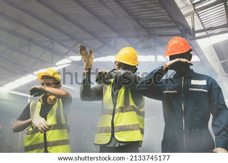 Group of male industrial workers are fleeing and covering their noses with their hands from the toxic fumes of toxic chemicals,ammonia,from violent explosions that make breathing dangerously difficult Royalty-Free Stock Photo #2133745177