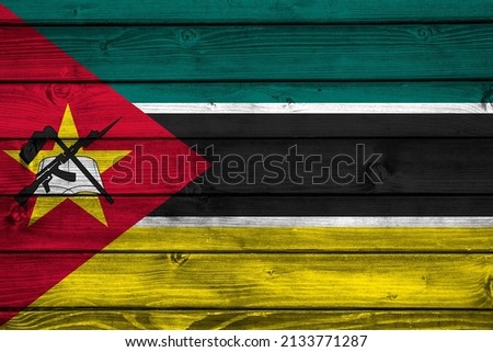 Flag of Mozambique on wooden surface