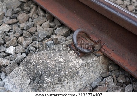 Close up and detailed photos of the commuter rail section and the gravel around it                                
