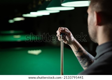 Close up of a unrecognizable man chalking pool cue
