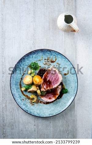 Modern style traditional Japanese tuna tataki with home fies soy sauce served as top view on a Nordic design plate Royalty-Free Stock Photo #2133799239