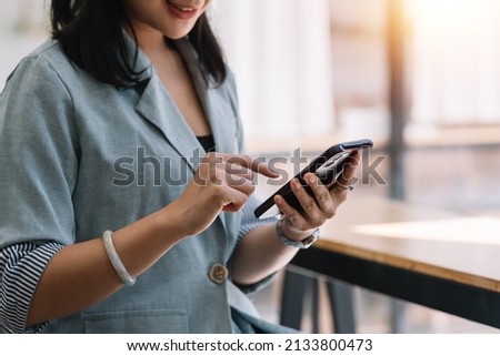 Woman using mobile phone to send text , work or play social media.