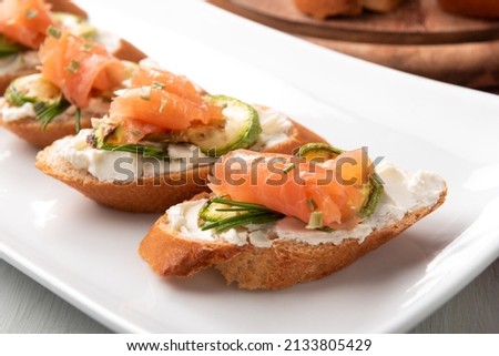 Dish of delicious crostini with smoked salmon, courgette and cheese, Italian appetizers Royalty-Free Stock Photo #2133805429