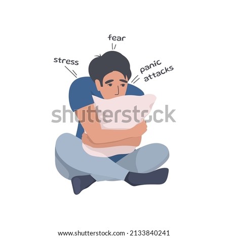 The man hugs the pillow in panic. Panic attacks, fear of the outside world, war and its consequences