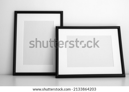 Two minimalist black frame mockup on white background in interior