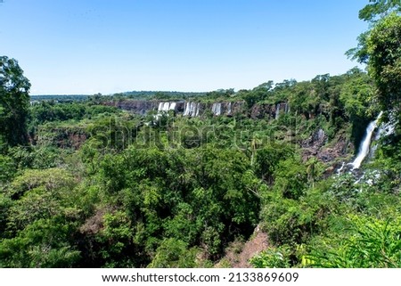 A landscape photo of the world wonder and famous Iguazu Waterfalls in Argentina between the green atlantic forest