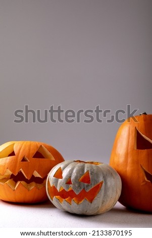 Composition of halloween jack o lanterns and copy space on grey background. horror, fright, halloween tradition and celebration concept digitally generated image.