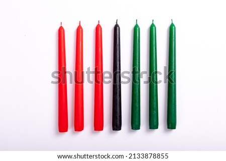 Composition of halloween candles in red black and green on white background. horror, fright, halloween tradition and celebration concept digitally generated image.