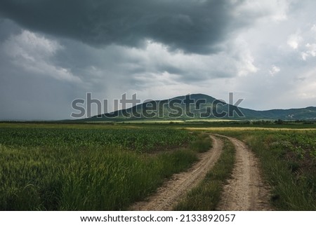 Road to the hills under rain clouds