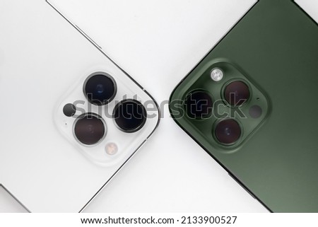 two smartphones on a white background Alpine Green. 
iphone 13 pro max alpine Green  Royalty-Free Stock Photo #2133900527