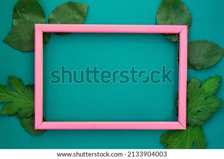 Pink frame on a green background. A postcard with a floral background. A photo with a place for the text. Mockup.