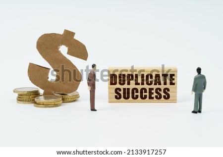 Economy and finance concept. On a white background, coins, a dollar symbol and figures of businessmen who look at a wooden plate with the inscription - Duplicate Success