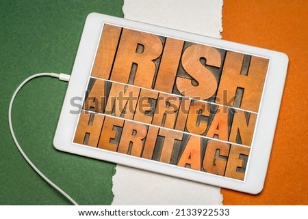 Irish American heritage - word abstract in vintage letterpress wood type on a digital tablet against paper abstract in colors of Ireland flag, reminder of cultural event