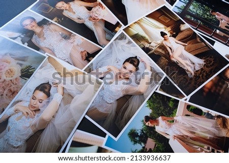 spread out a printed copy of the wedding photos. the result of the photographer's work at the wedding. printed products. a photo session of the bride.
